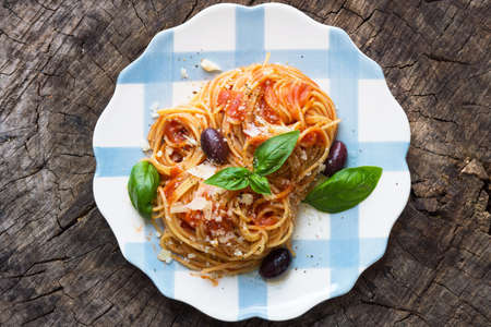 Spaghetti with tomato sauce on wooden backgroundの写真素材