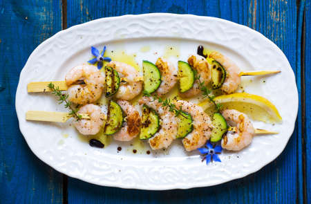 Shrimps skewers with zucchini on wooden backgroundの写真素材