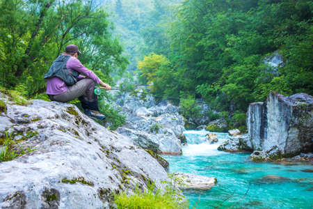A fly fisherman fishing in a riverの写真素材