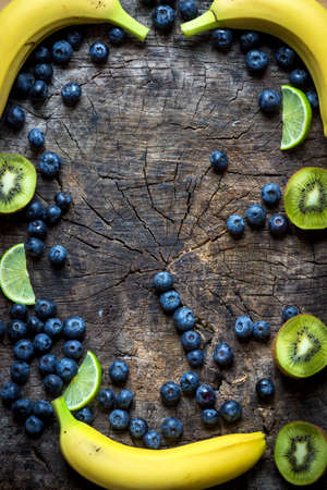 Studio photo of different fruits and vegetables on  wooden table.の写真素材