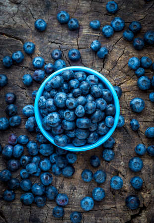 Freshly picked blueberries on wooden backgroundの写真素材