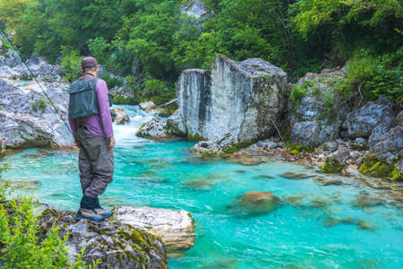 A fly fisherman fishing in a river