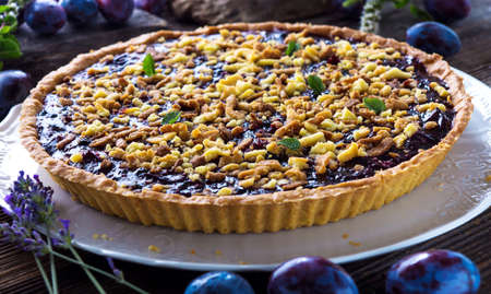 Homemade organic plum pie on wooden backgroundの写真素材