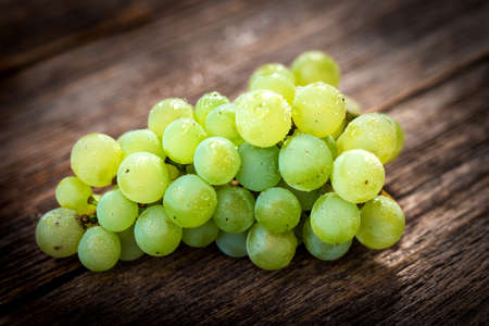 White grapes on wooden background
