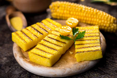 Grilled polenta on old wooden backgroundの写真素材