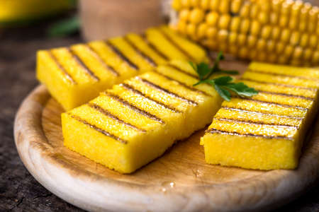 Grilled polenta on old wooden backgroundの写真素材