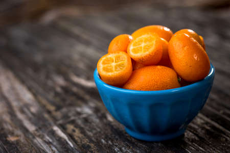 Raw Organic  Kumquats on wooden backgroundの写真素材