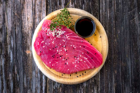 Raw tuna fillet with soya sauce  on rustic backgroundの写真素材