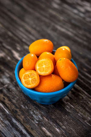 Raw Organic  Kumquats on wooden backgroundの写真素材