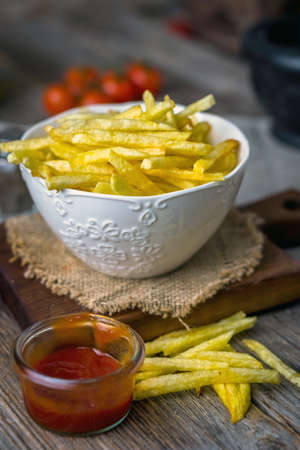 Homemade french fries on wooden  background
