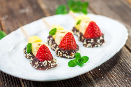 Fresh Fruit skewers with chocolateの写真素材