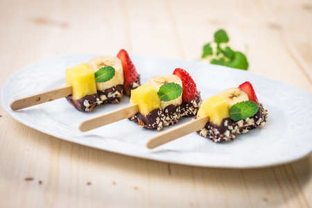 Fresh Fruit skewers with chocolateの写真素材