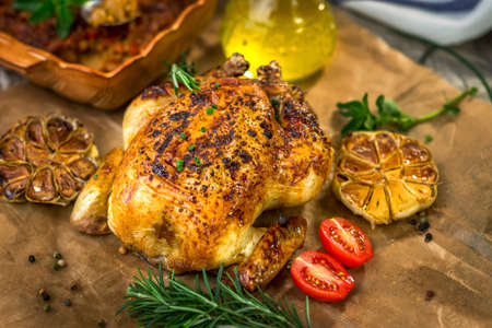 Roasted whole chicken on backing paperの写真素材