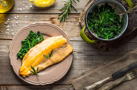 Trout fillet with spinachの写真素材