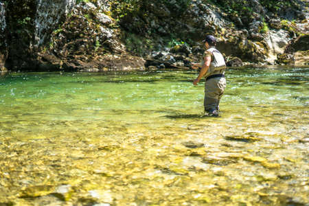 Fly fisherman flyfishing in riverのeditorial素材