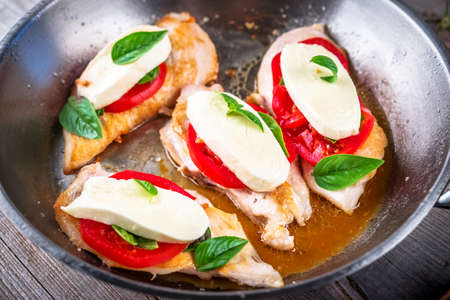 Chicken breast stuffed with mozzarella; basil and tomatoesの写真素材