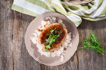 Plate of sausages and sauerkraut on wooden tableの写真素材
