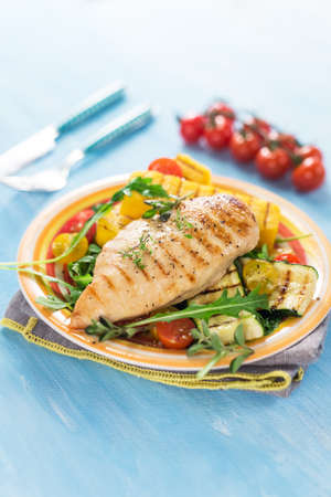 Grilled chicken breast with vegetables and polentaの写真素材