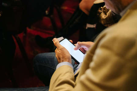 A man uses the mobile phone in a congress