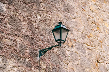 Detail of a lamppost on a stone wallの写真素材