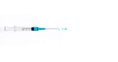 Isolated syringe with blue liquid on white background. Medicine and health concept in the face of a pandemic or virus.の写真素材