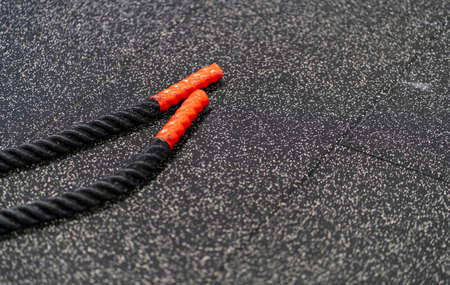Black gym rope on the rubber floor of the training area