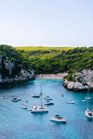 MENORCA, SPAIN. 3 SEPTEMBER 2020. Panoramic view of Cala Macarelleta with people on their boats enjoying a day of vacation.のeditorial素材