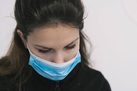 Beautiul caucasian female sanitary with blue protection maskの写真素材