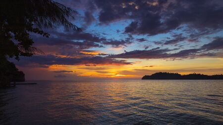beach at sunset with island in the backgroundの写真素材