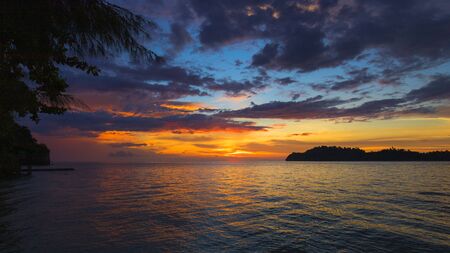 beach at sunset with island in the backgroundの写真素材