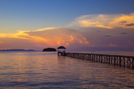 beach with walkway to the sea at sunsetの写真素材