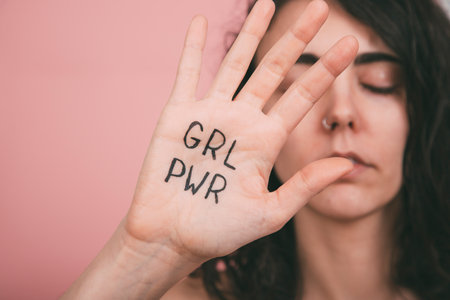 Woman's hand with girl power painted lettersの写真素材