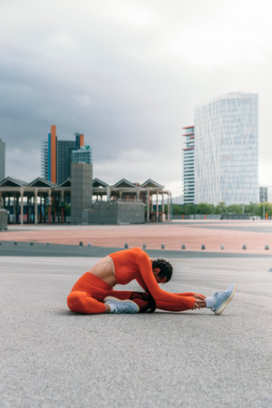 Female athlete stretching leg before running. Young caucasian woman morning workout routine. Vertical image. Sports concept. Active Healthy lifestyle concept. Vertical image. Copy spaceの写真素材