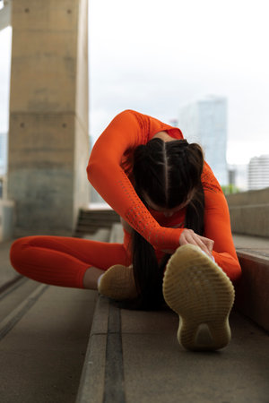 Female runner doing stretching exercise. Vertical image. Woman morning workout routine. Fitness concept. Active lifestyle concept.の写真素材