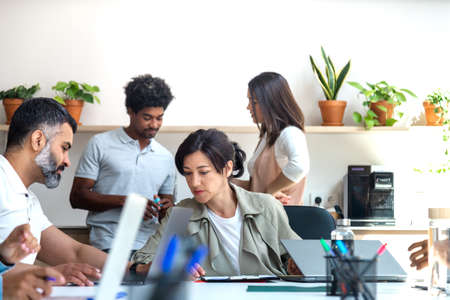 Group of multiracial colleagues working at the office. Coworkers standing on the background.の写真素材