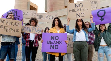 Multiracial demonstrators looking at camera holding protest signs for womens rights. No means no. Panoramic banner.の写真素材