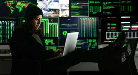 Horizontal banner image of hispanic female hacker hacking security firewall late at night. Multiple...