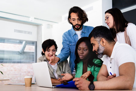 Group of multiracial colleagues work together on a project. Brainstorming and sharing ideas in the...