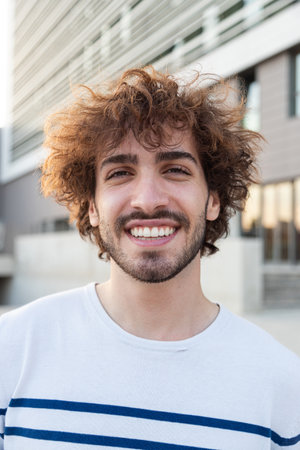 Vertical portrait of confident happy young man looking at camera.