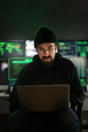Hacker using laptop to organize malware attack on global scale.Vertical image.の写真素材