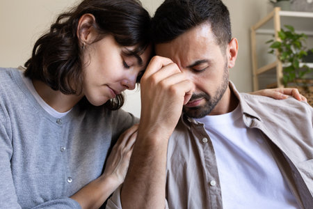 Close up of woman comforting husband.の写真素材