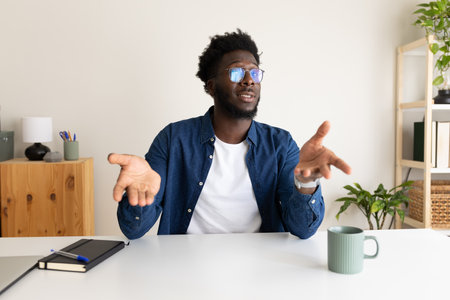 Young African American man on a video call. Black male on online business meeting.の写真素材