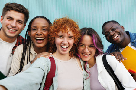 Happy diverse students taking selfie and smiling at cameraの写真素材