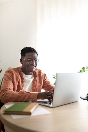 Smiling freelancer working from home on laptopの写真素材