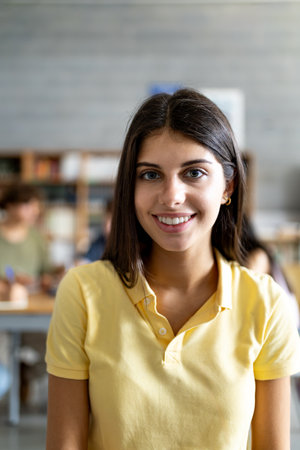 Young female college student smiling in library study roomの写真素材