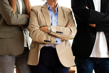 Close up image of three unrecognizable business people with arms crossed.の写真素材
