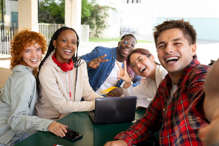 Cheerful university students taking selfie after successful exam resultの写真素材
