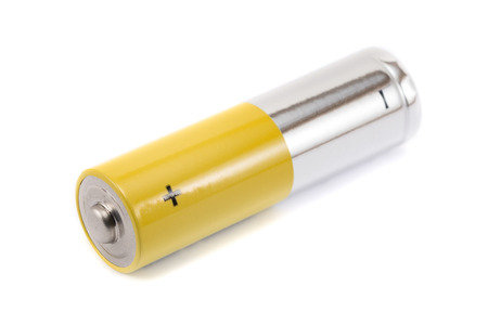 alkaline batteries and a yellow metal AA-size batteries isolated on white background closeup, carbon...
