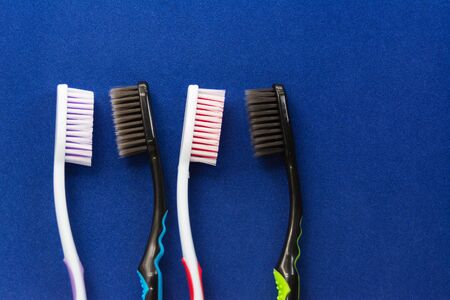 toothbrushes are multicolored on a bright blue background close-up