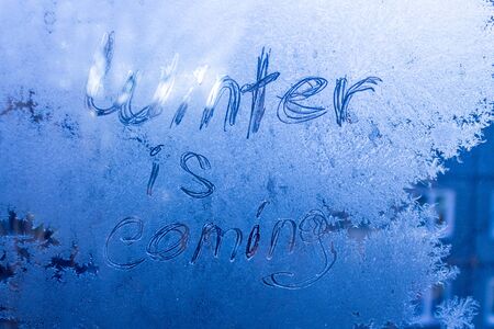 the inscription on the frozen winter glass, winter on the windowの写真素材